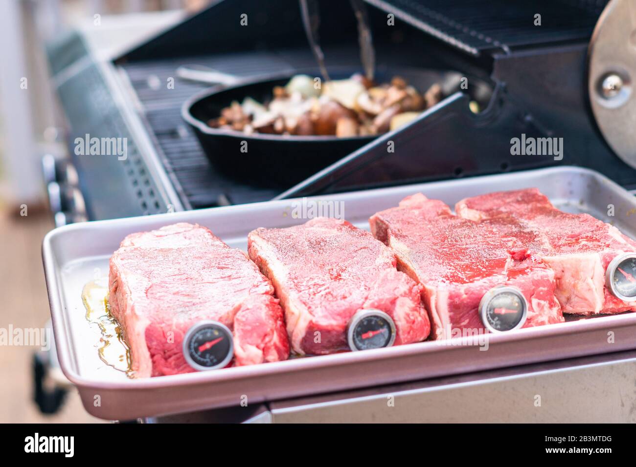 Grilling New York strip steak on outdoor gas grill Stock Photo Alamy