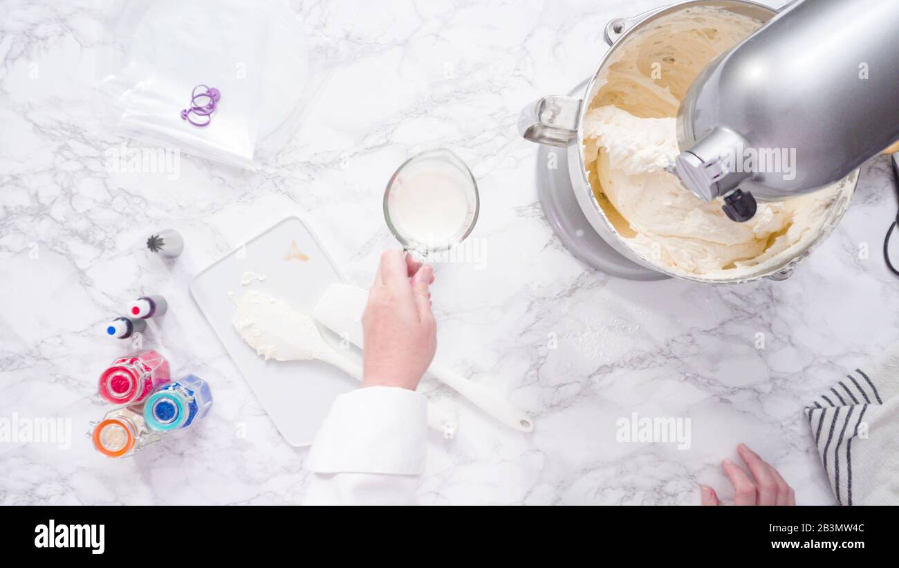 Mixing ingredients in standing kitchen mixer to make buttercream