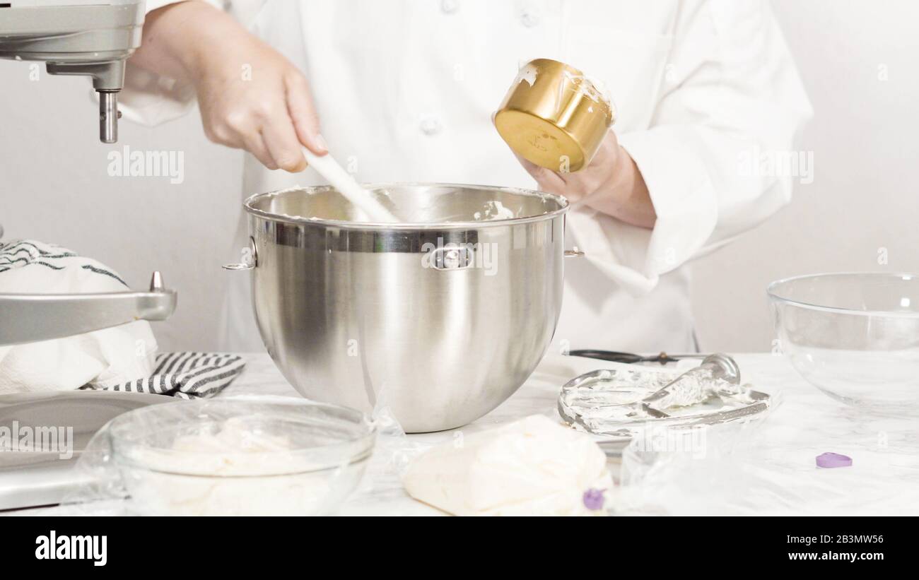 Mixing ingredients in standing kitchen mixer to make buttercream