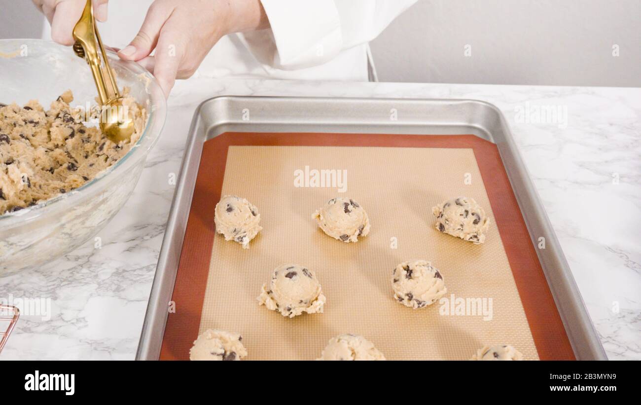 Step by step. Scooping homemade chocolate chip cookies with metal dough