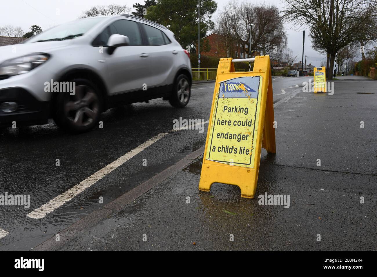 Parking here could endanger a child's life signs outside Hilltop first school Windsor. Signs are placed on the zigzag lines to discourage parking. Stock Photo