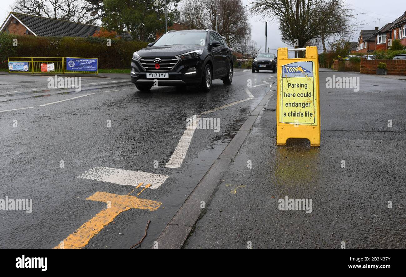 Parking here could endanger a child's life signs outside Hilltop first school Windsor. Signs are placed on the zigzag lines to discourage parking. Stock Photo