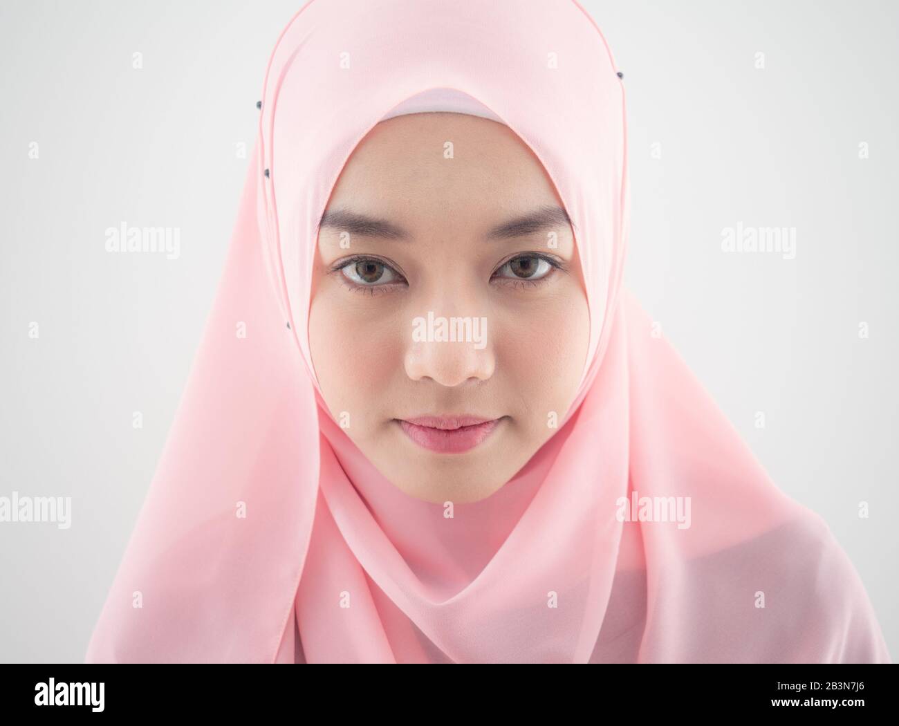 Close up Portrait of a beautiful Muslim Asian woman in a pink hijab on ...