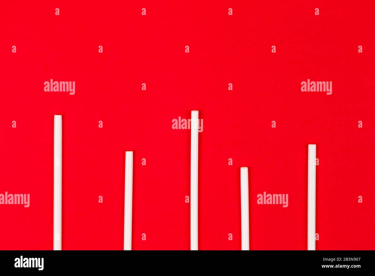 Plastic cocktail straws arranged in columns of statistics graph on a