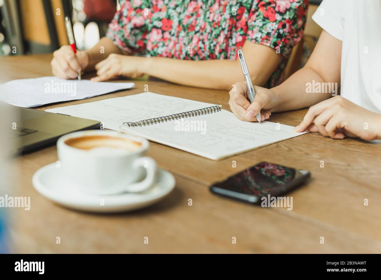 Business woman hands writing on notebook documents. Stock Photo