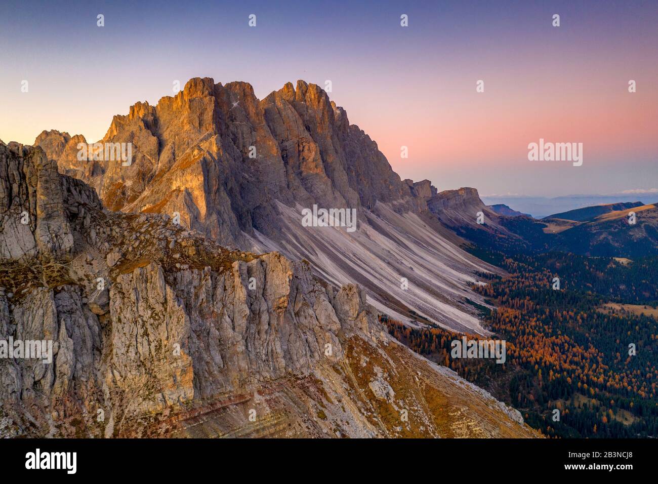 Autumn trees at feet of Furchetta and Sass Rigais, aerial view, Puez-Odle, Funes Valley, Dolomites, Bolzano, South Tyrol, Italy, Europe Stock Photo