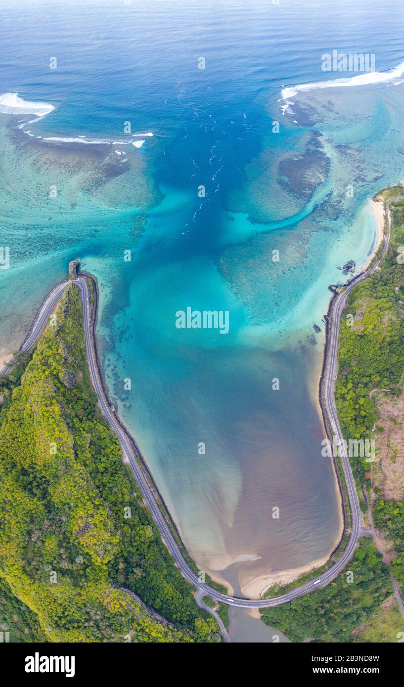 Coastal road facing the turquoise lagoon, aerial view by drone, Bel
