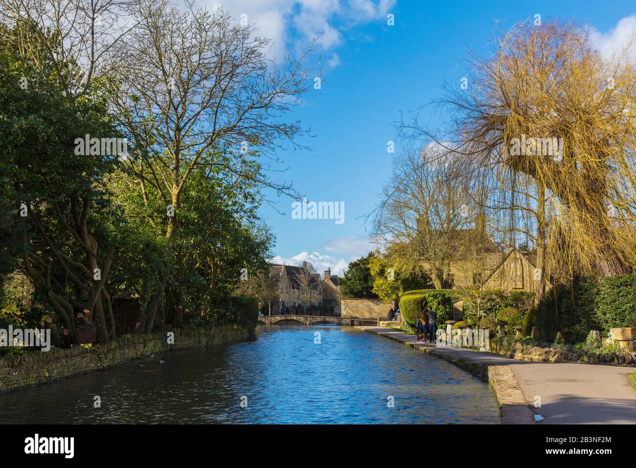 The River Windrush Flowing Through the Centre of Bourton-on-the-Water a Village in the Cotswolds AONB on a Bright Spring Morning Stock Photo