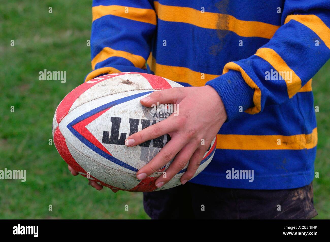 Boy holding rugby ball UK Stock Photo Alamy
