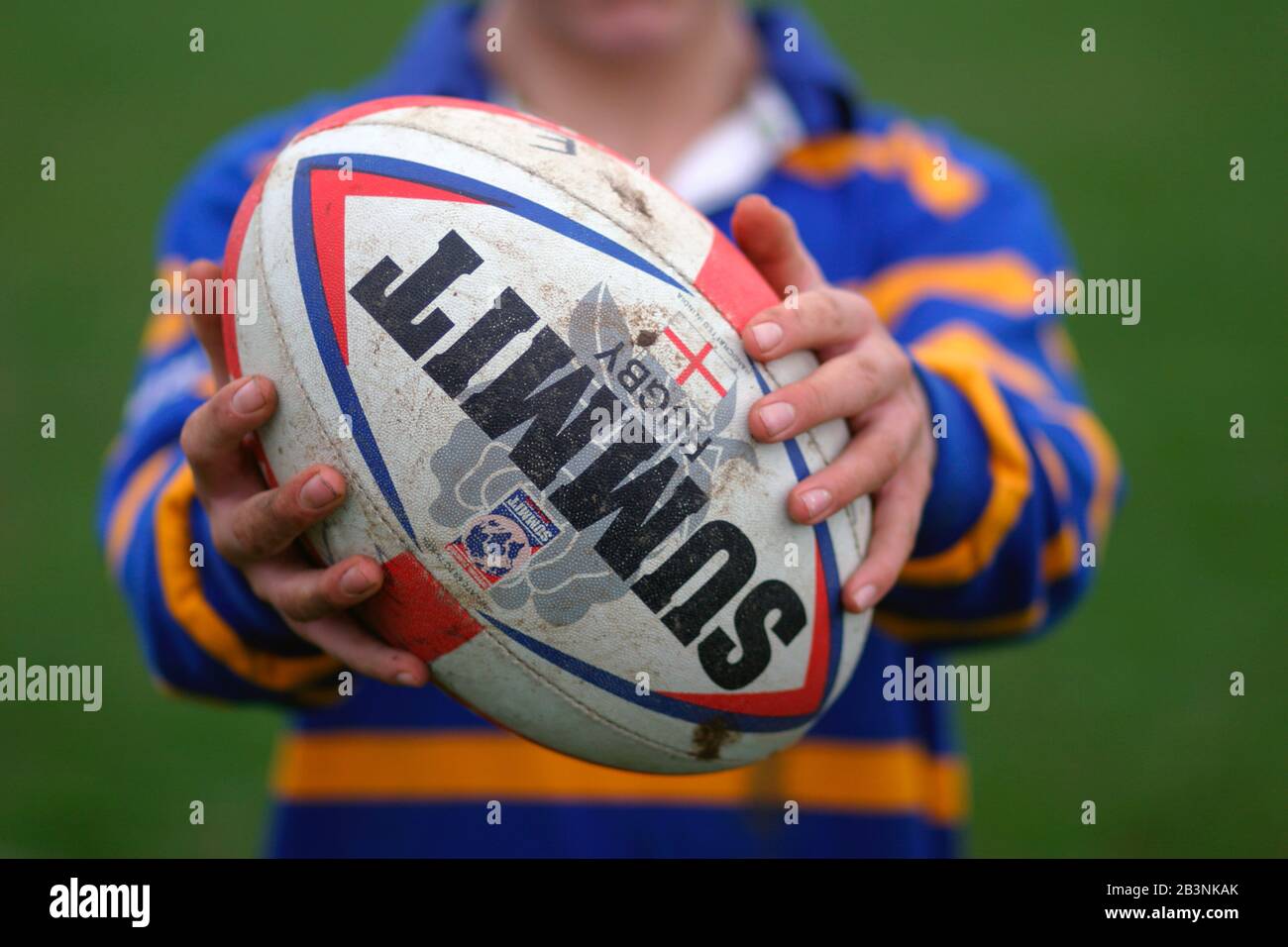 Boy holding rugby ball UK Stock Photo Alamy