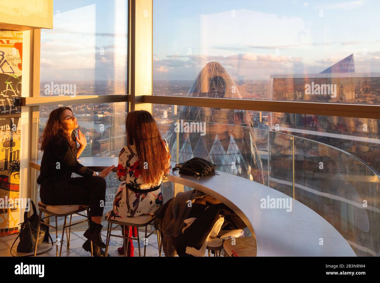 Customers in the Duck and Waffle skyline restaurant; 110 Bishopsgate building (aka Heron Tower) interior, East London London UK Stock Photo