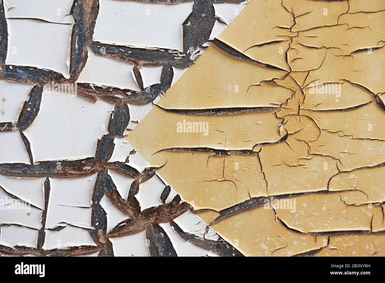 Abstract corroded old paint on metal wall. Cracked white beige yellow metal rust texture background Stock Photo