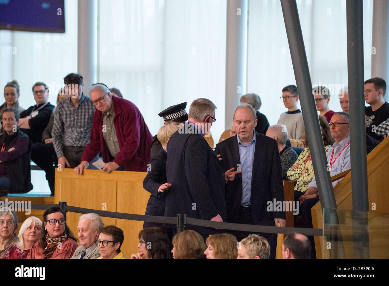 Edinburgh, UK. 5th Mar, 2020. Pictured: A protestor is escorted out of the gallery in the debating chamber during the end of First Ministers Questions. Parliament was suspended whilst the protestor was escorted outside by Police and security. Scenes from First Ministers Questions at the Scottish Parliament in Holyrood, Edinburgh. Credit: Colin Fisher/Alamy Live News Stock Photo