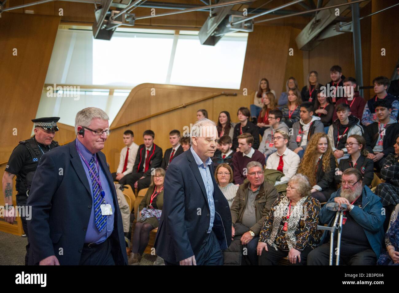 Edinburgh, UK. 5th Mar, 2020. Pictured: A protestor is escorted out of the gallery in the debating chamber during the end of First Ministers Questions. Parliament was suspended whilst the protestor was escorted outside by Police and security. Scenes from First Ministers Questions at the Scottish Parliament in Holyrood, Edinburgh. Credit: Colin Fisher/Alamy Live News Stock Photo