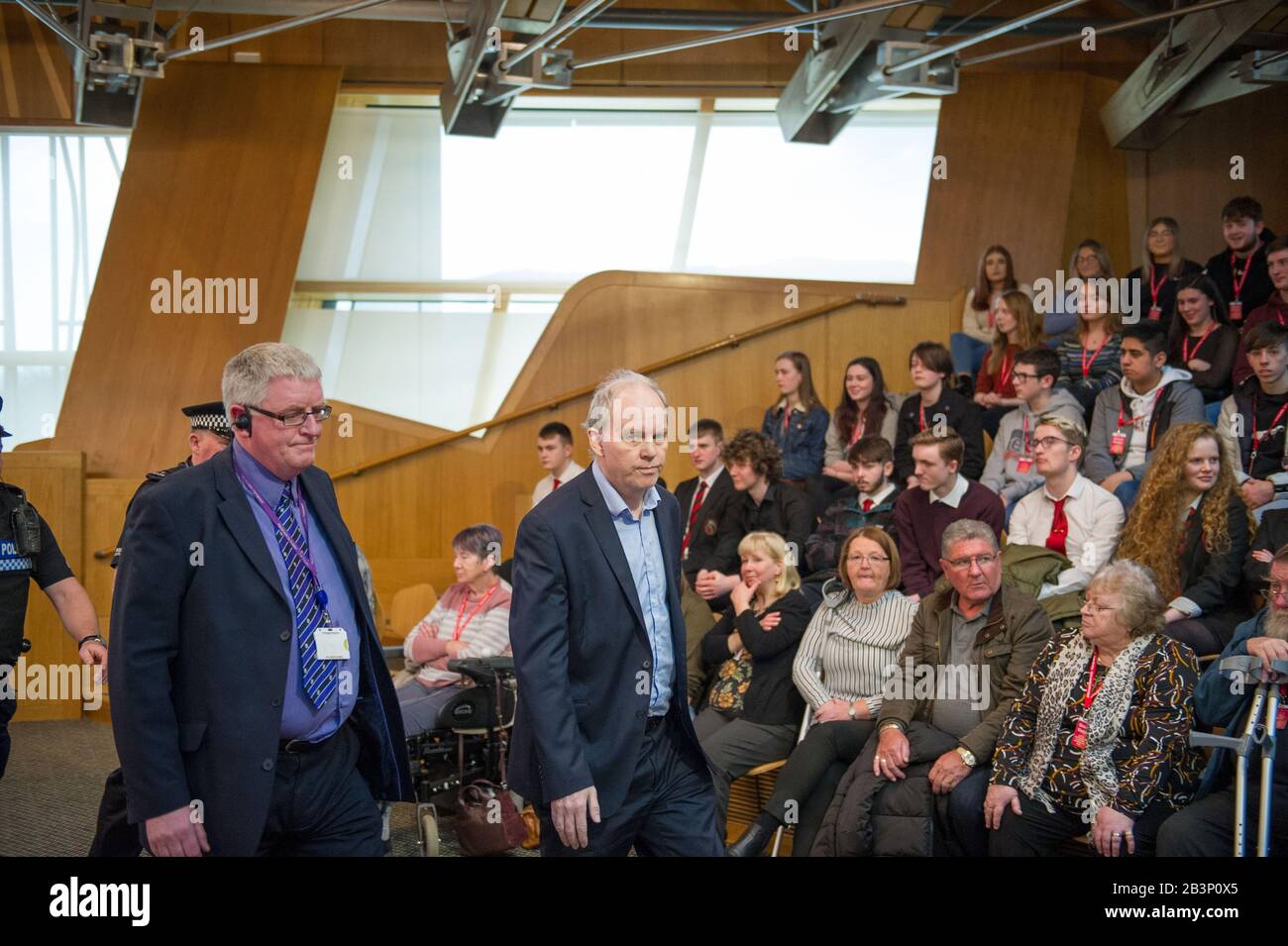 Edinburgh, UK. 5th Mar, 2020. Pictured: A protestor is escorted out of the gallery in the debating chamber during the end of First Ministers Questions. Parliament was suspended whilst the protestor was escorted outside by Police and security. Scenes from First Ministers Questions at the Scottish Parliament in Holyrood, Edinburgh. Credit: Colin Fisher/Alamy Live News Stock Photo