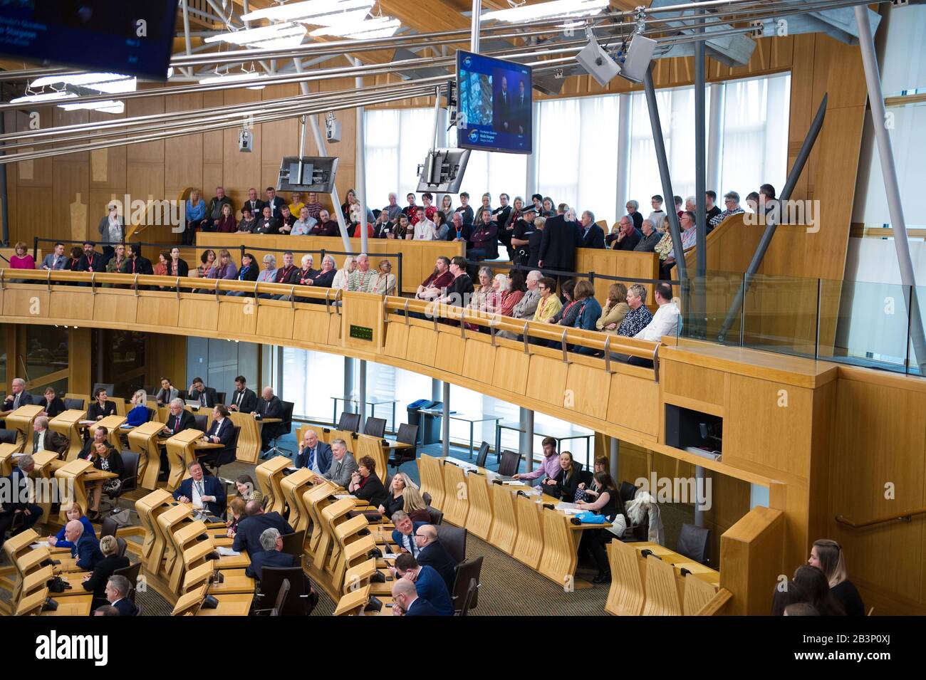 Edinburgh, UK. 5th Mar, 2020. Pictured: A protestor is escorted out of the gallery in the debating chamber during the end of First Ministers Questions. Parliament was suspended whilst the protestor was escorted outside by Police and security. Scenes from First Ministers Questions at the Scottish Parliament in Holyrood, Edinburgh. Credit: Colin Fisher/Alamy Live News Stock Photo