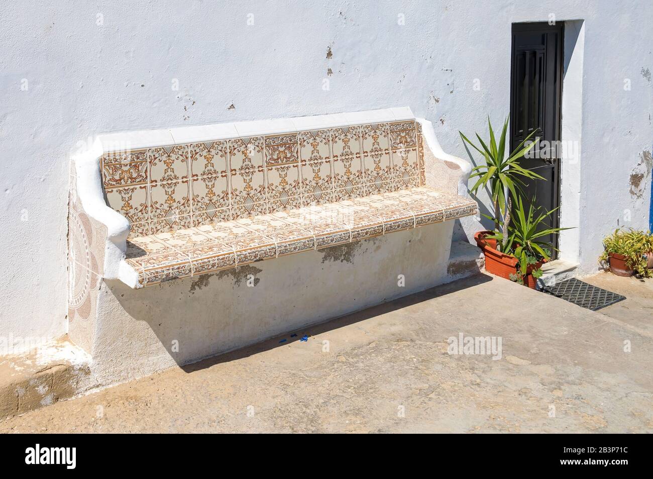 Bench decorated with traditional portuguese tiles called azulejos ath the house entrance Stock Photo