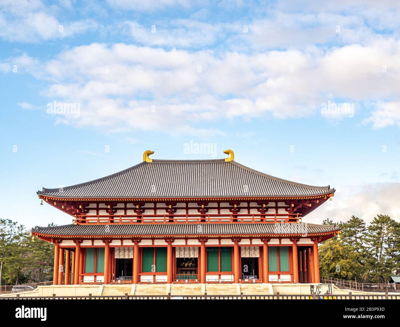 Orange Buddhist temple Kofukuji, with gold curved roof ornaments in