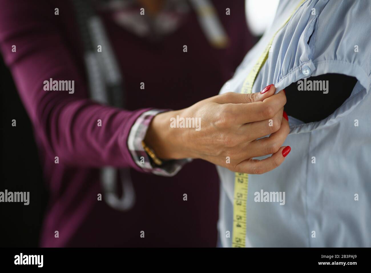 Tailor measures armhole length mannequin clothes Stock Photo Alamy