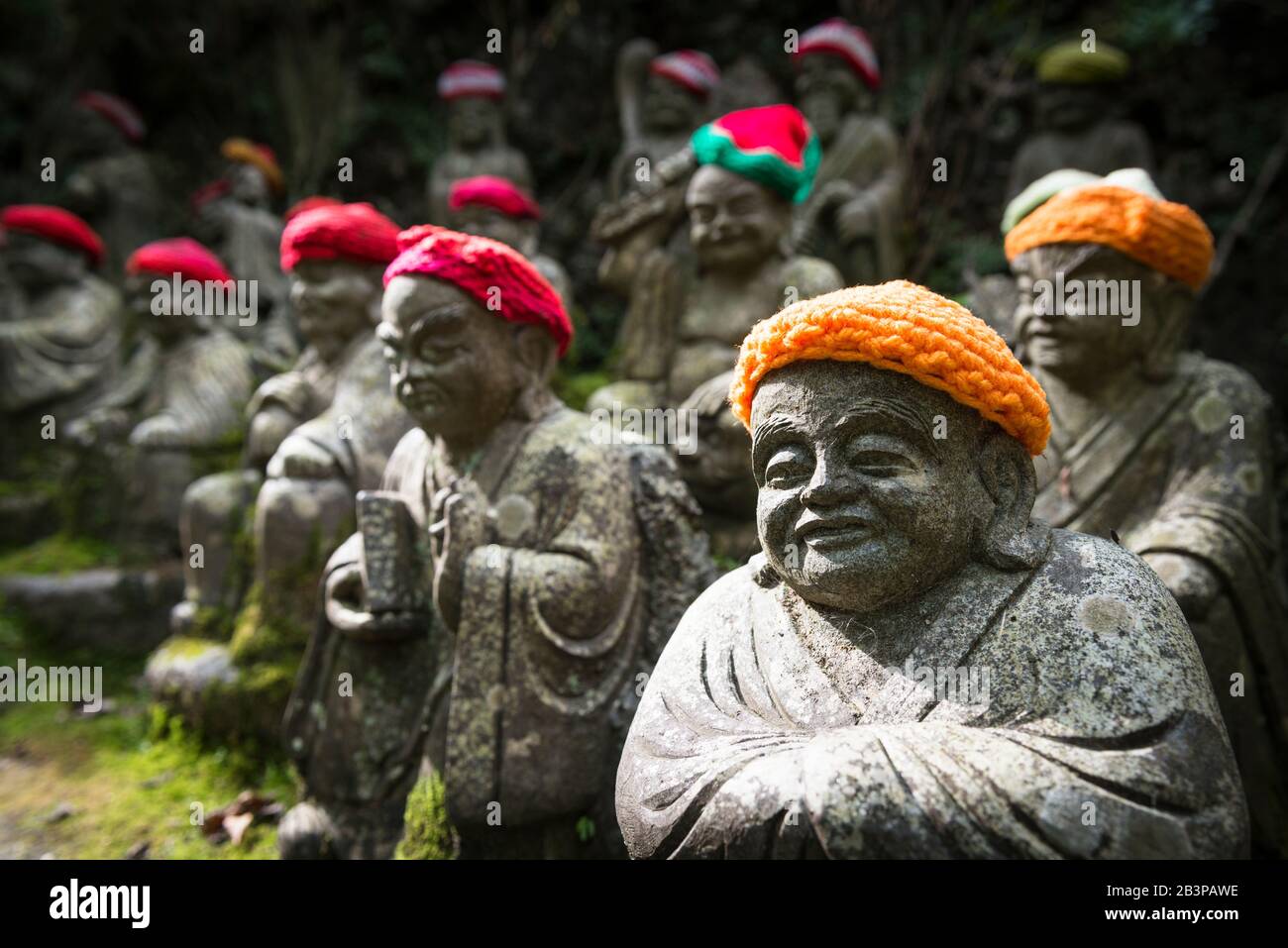 Stone buddha statues with colourful knitted hats within Daisho-in Temple complex, a prestigious Shingon temple, on Mount Mison Miyajima Island Stock Photo