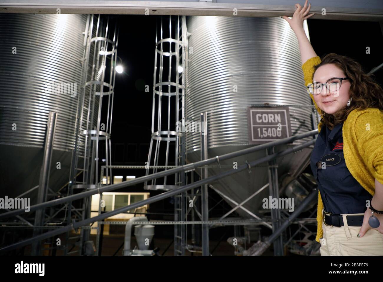 Female tour guide showing the corn storage bins to visitors during the tour of Old Dominick Distillery.Downtown Memphis.Tennessee.USA Stock Photo