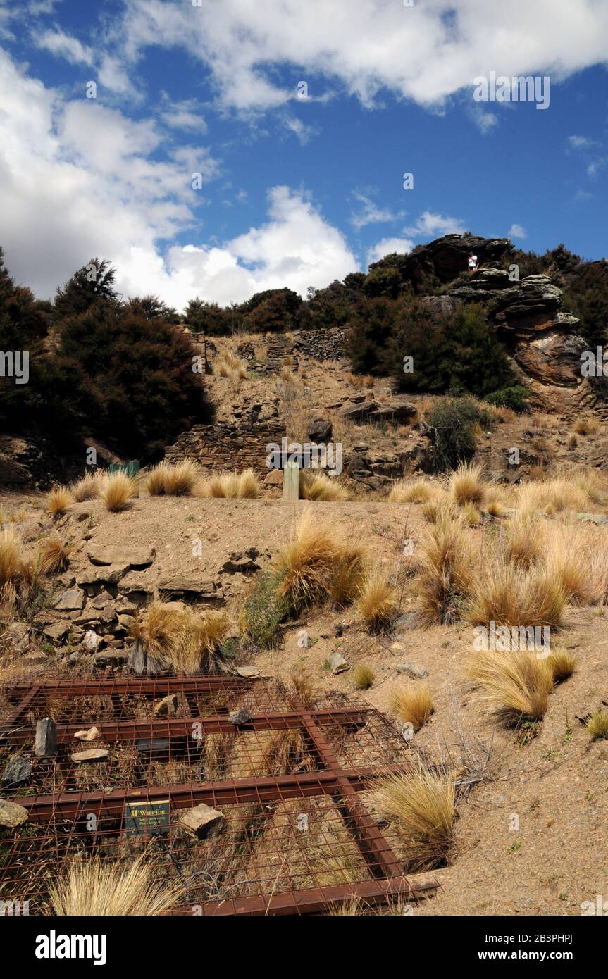 A steel and wire grill blocks off a mine shaft in the old gold mining area in the Bendigo Historic Reserve, Central Otago, New Zealand. Stock Photo