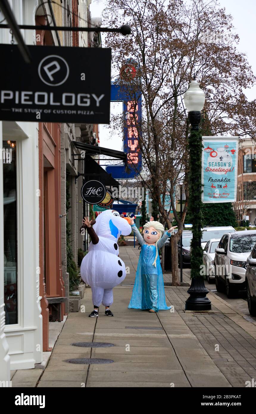 Frozen Characters Elsa and Olaf walking down the Main Street in historical downtown Franklin.Tennessee.USA Stock Photo