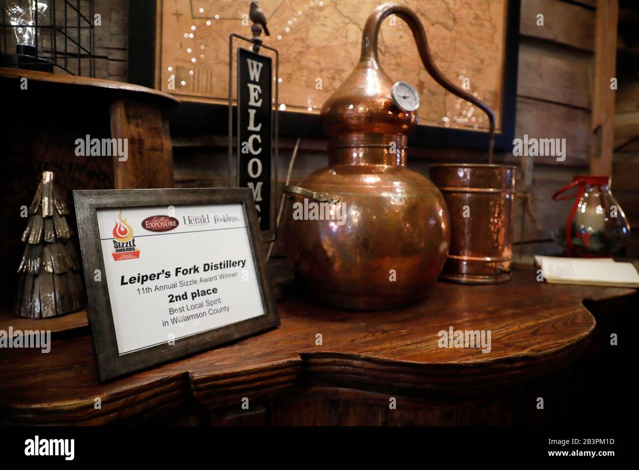 A 2nd place Certificate of Merit for Leiper's Fork Distillery for the Best Local Spirt in Williamson County next to a small Cooper still. Franklin.Tennessee.USA Stock Photo