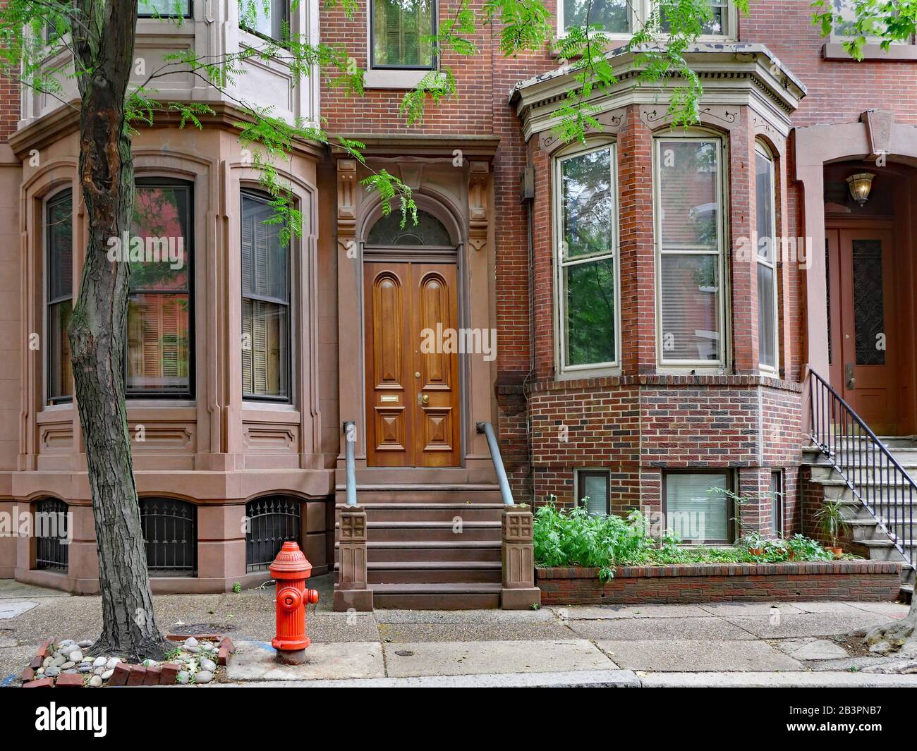 Urban brownstone building with bay windows Stock Photo - Alamy