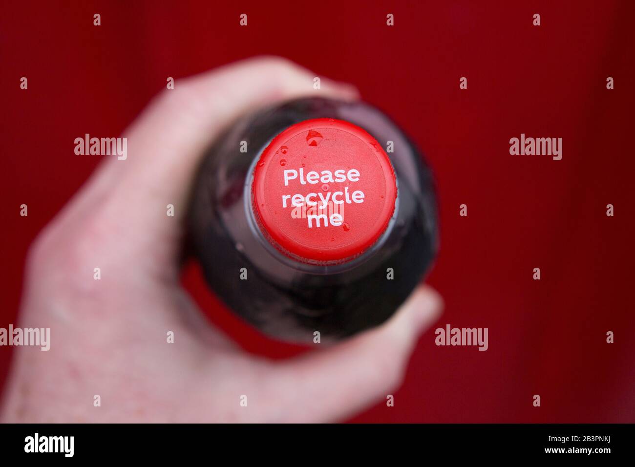 Recycling plastic waste concept idea. Hand holding coke coca cola