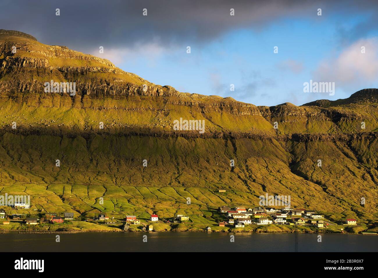 Coastal village of Signabour in sunset light, Faroe Islands Stock Photo