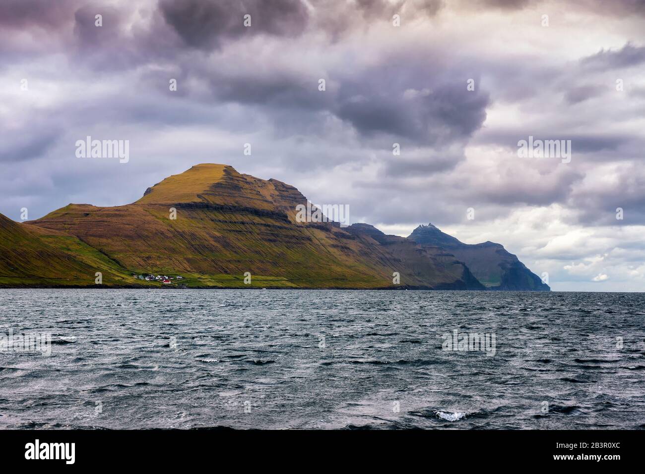 Village of Sydradalur and the island of Kalsoy in Faroe Islands, Denmark Stock Photo