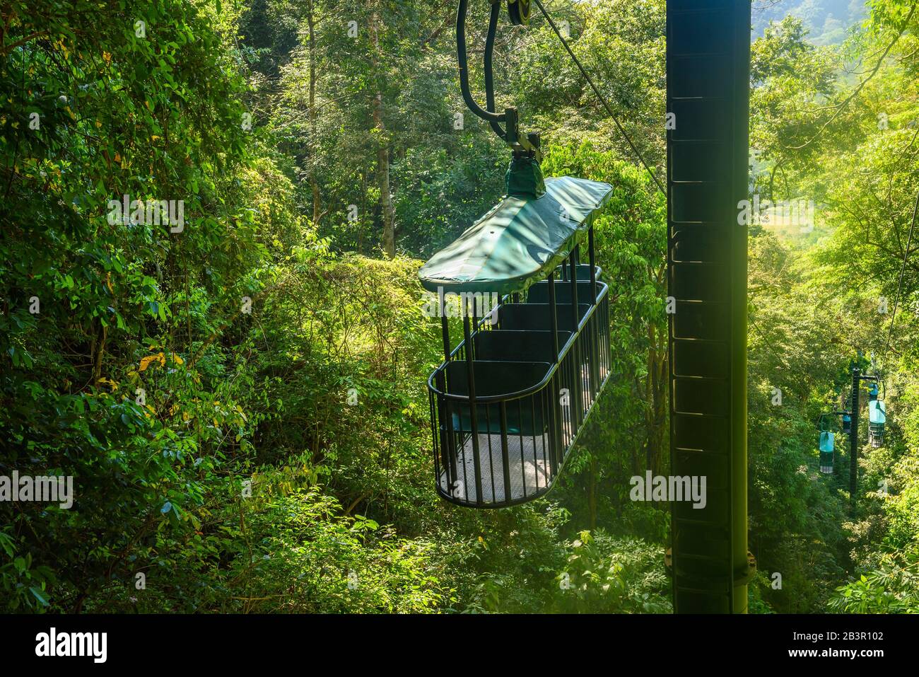 Cable car cabin riding through the tropical rainforest near Jaco in Costa Rica Stock Photo