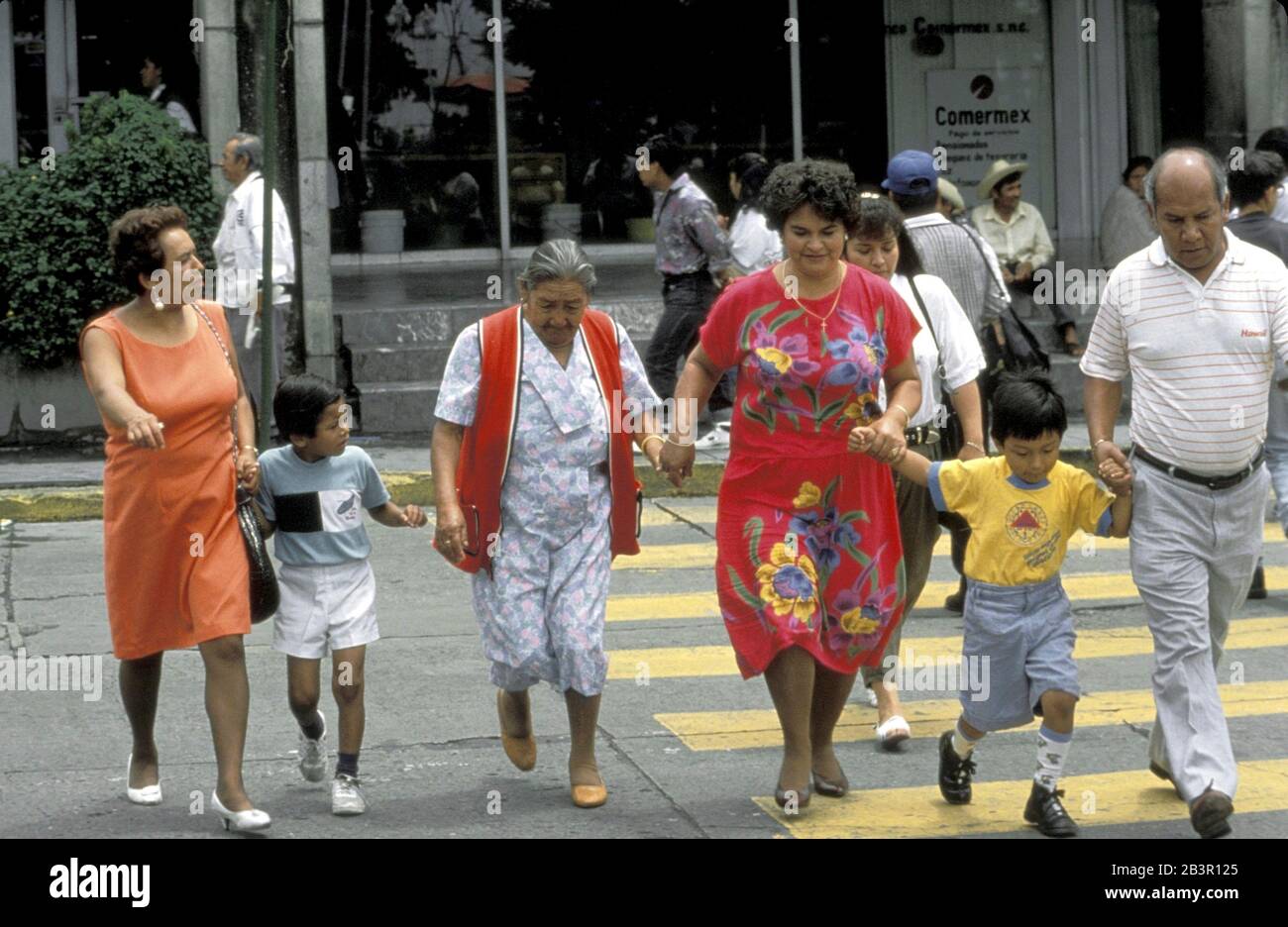 Cuernavaca, Mexico, circa 1990: Extended Mexican family crossing street. ©Bob Daemmrich Stock Photo