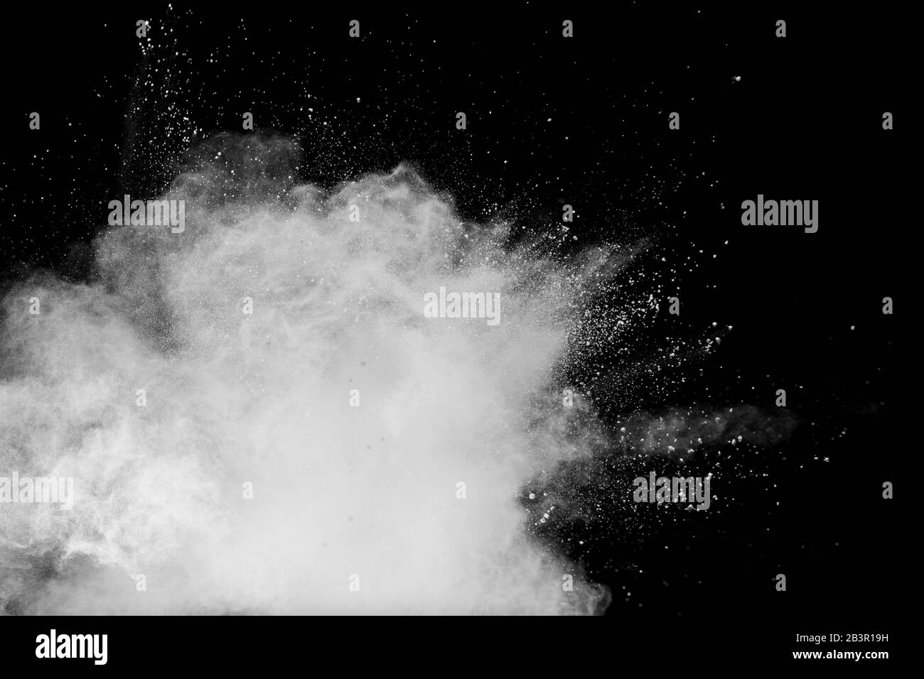 White talcume powder explosion on black background. White dust particles splash. Stock Photo