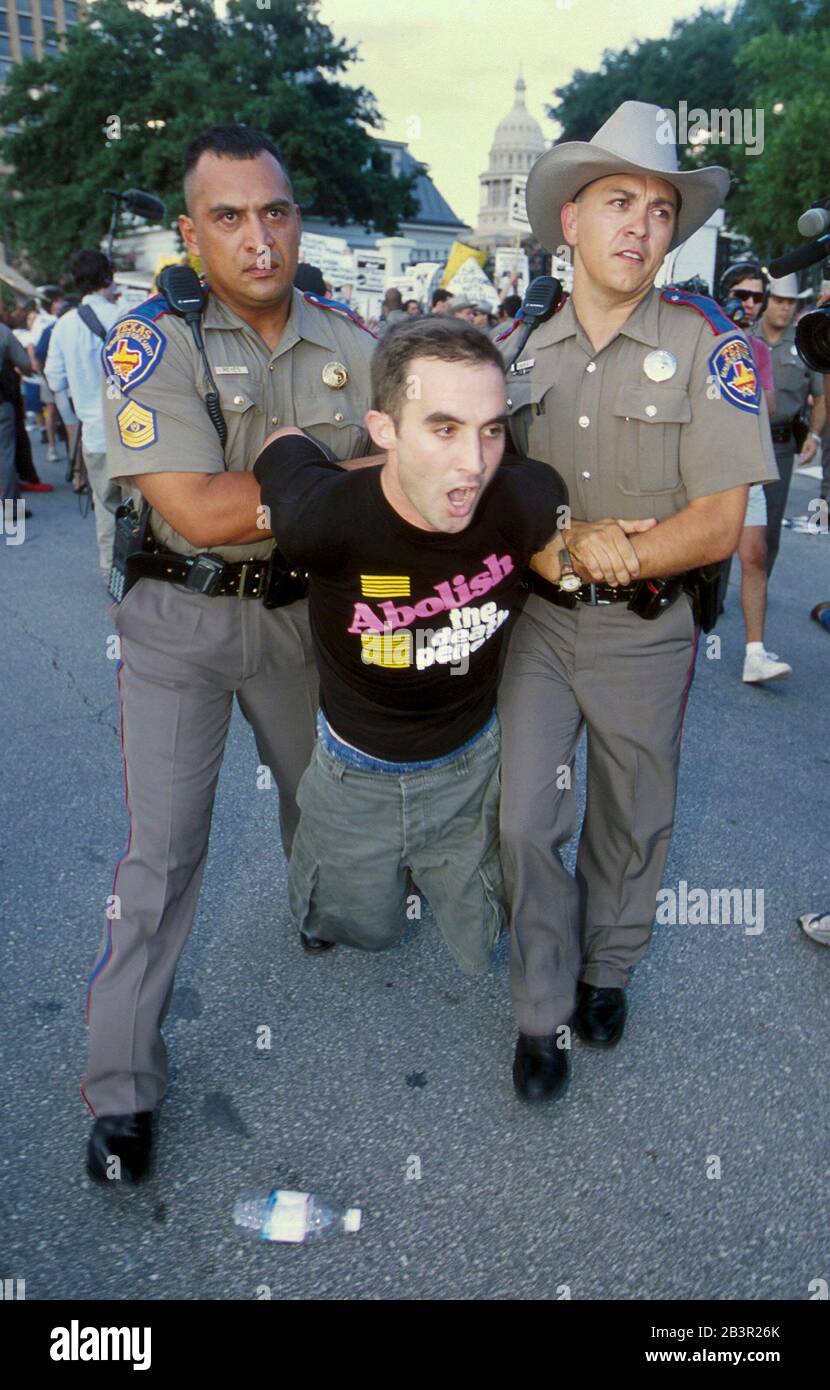 Austin, Texas USA, June 19 2000:  Anti-death penalty protesters are forcibly arrested by Texas Dept. of Public Safety officers outside the Governor's Mansion after blocking the rear entrance to Gov. George W. Bush's residence. About 20 people were removed after a tense standoff. ©Bob Daemmrich Stock Photo