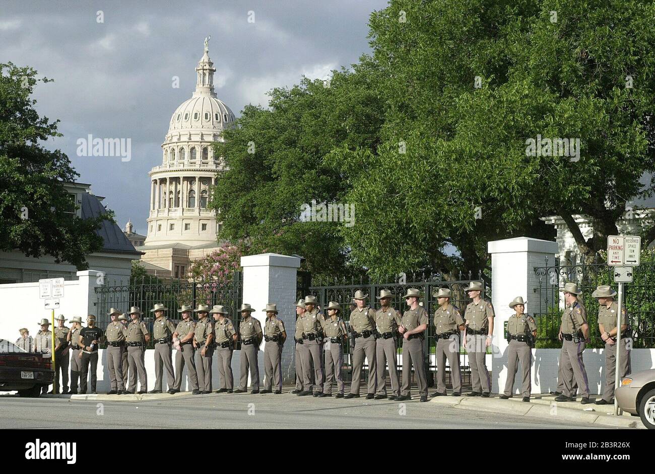 Austin, Texas USA, June 19 2000: Texas Department of Public Safety troopers guard the rear entrance to the  Governor's Mansion, home of presidential candidate George W. Bush, Monday following an anti-death penalty protest that resulted in the arrest of more than 20 demonstrators. The protesters, blocking the driveway, were calling for a moratorium on all executions in Texas. ©Bob Daemmrich Stock Photo