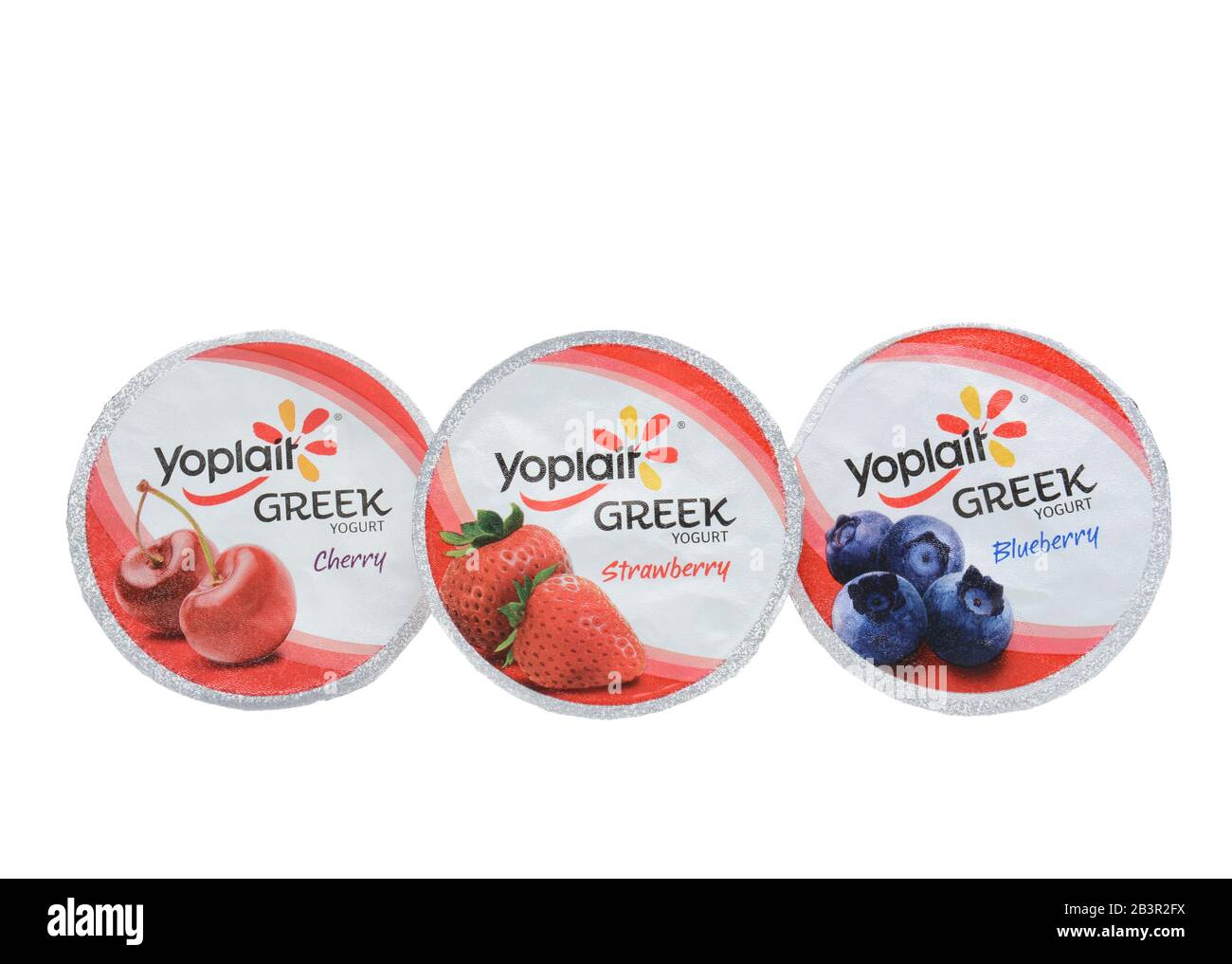 IRVINE, CA - SEPTEMBER 15, 2014: Three different containers of Yoplait Greek Yogurt isolated on white. In 1965, two French dairy co-operatives, Yola a Stock Photo