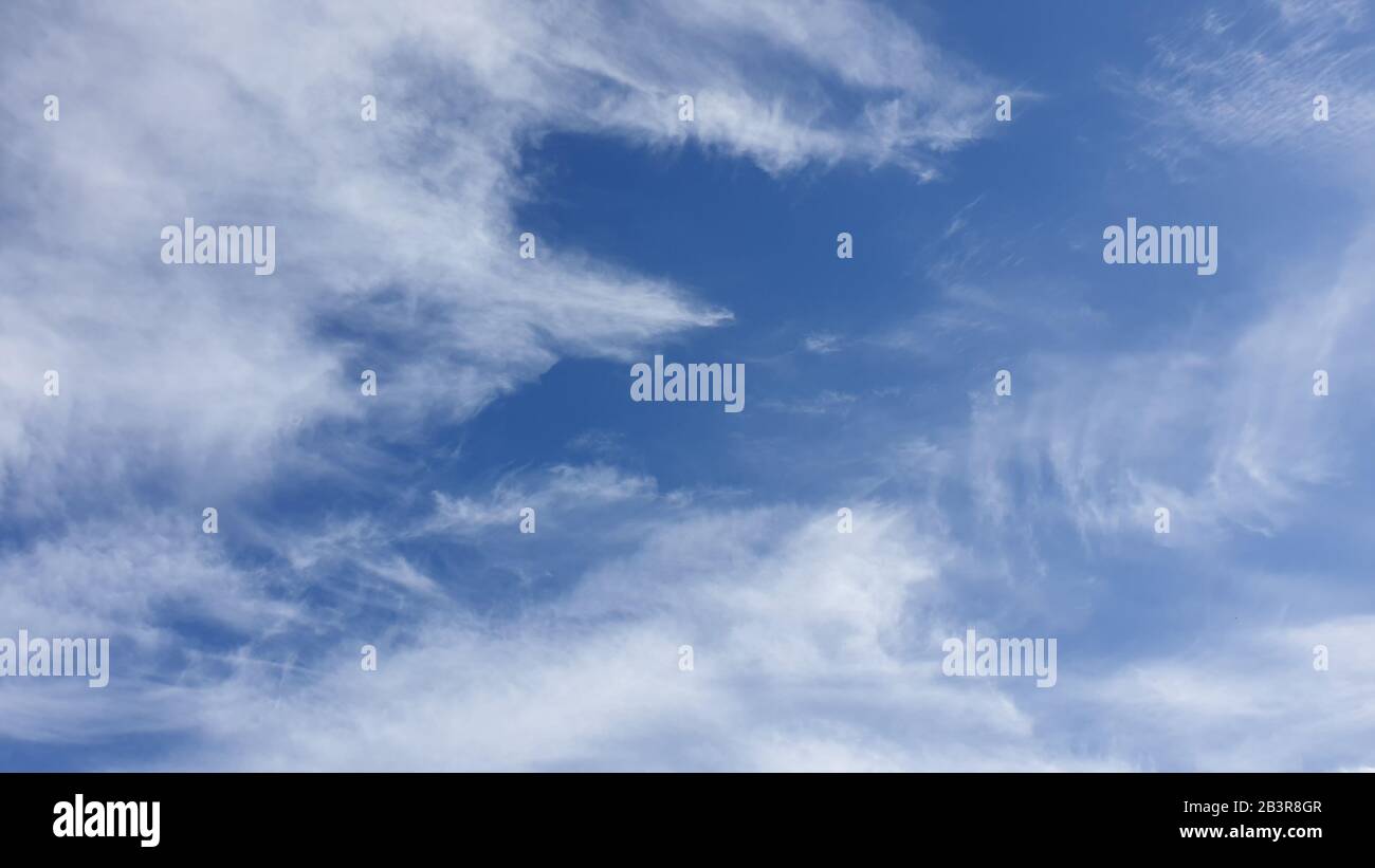 Fluffy white clouds and blue sky Stock Photo - Alamy
