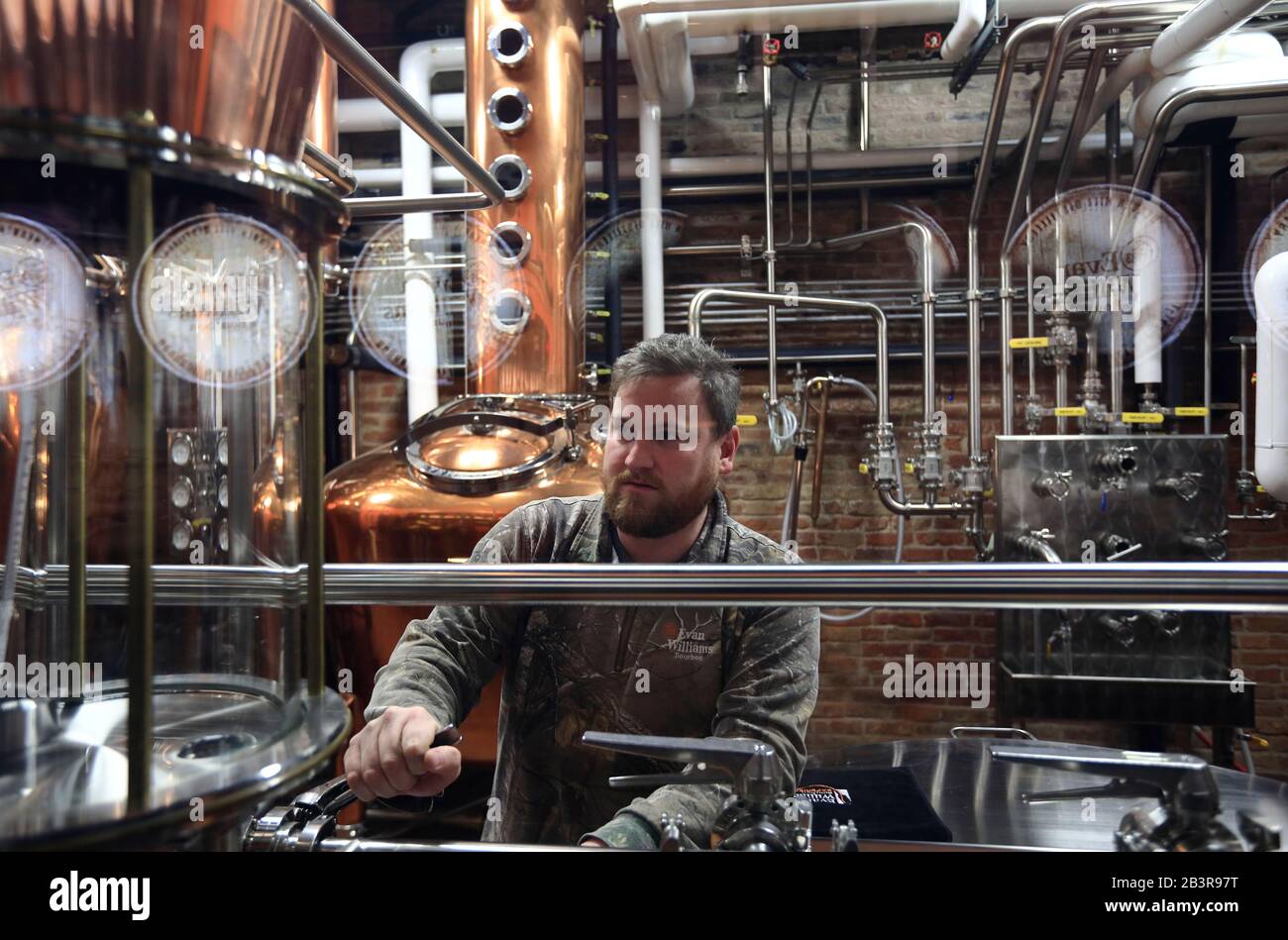 A technician using alcohol hydrometer to check the alcohol proof of newly distilled Bourbon whiskey Evan Williams Distillery.Evan Williams Bourbon Experience.Louisville.Kentucky.USA Stock Photo