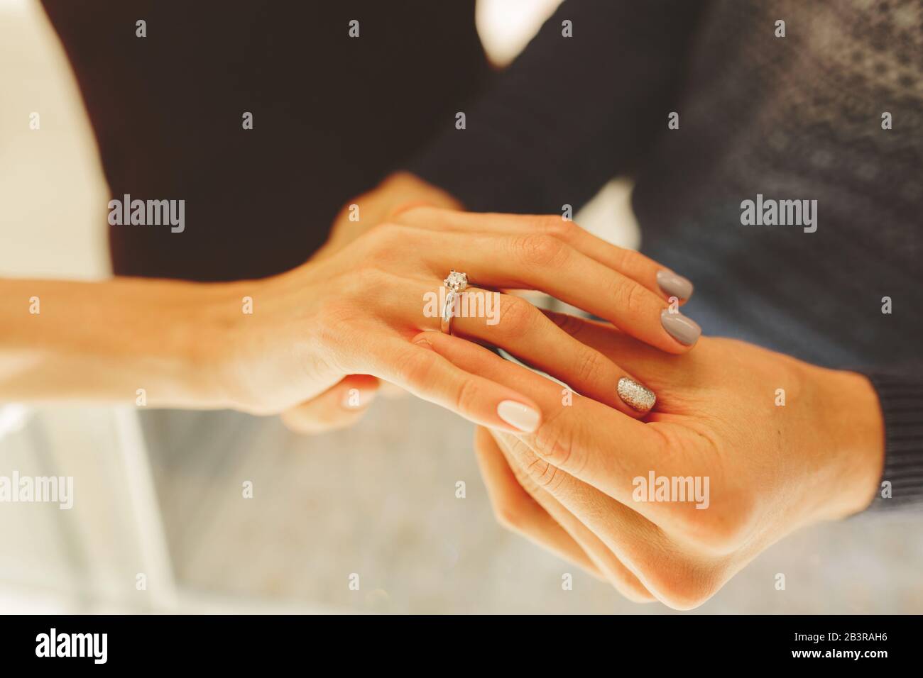 picture of man and woman with wedding ring, newlyweds choose and buy a wedding ring in a jewelry store Stock Photo