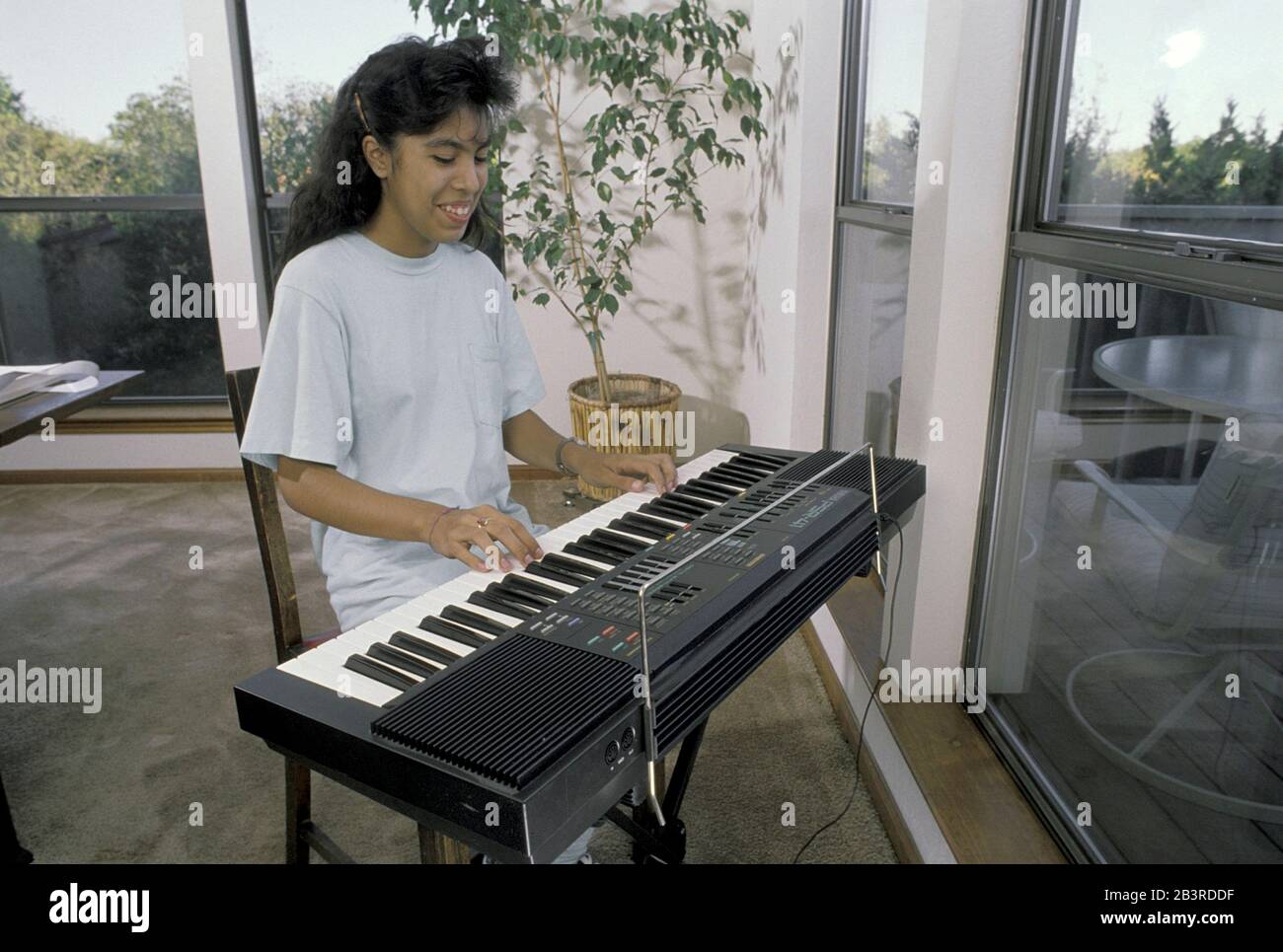 Austin Texas USA, circa 1990: Hispanic seventh grade girl practices ...