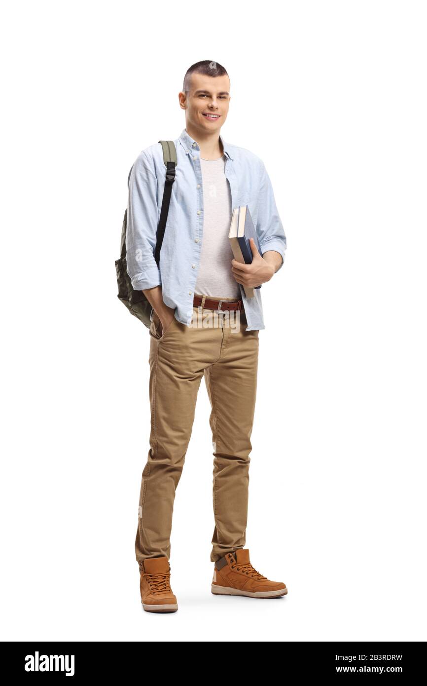 Full length portrait of a male student with books and backpack and smiling at the camera isolated on white background Stock Photo