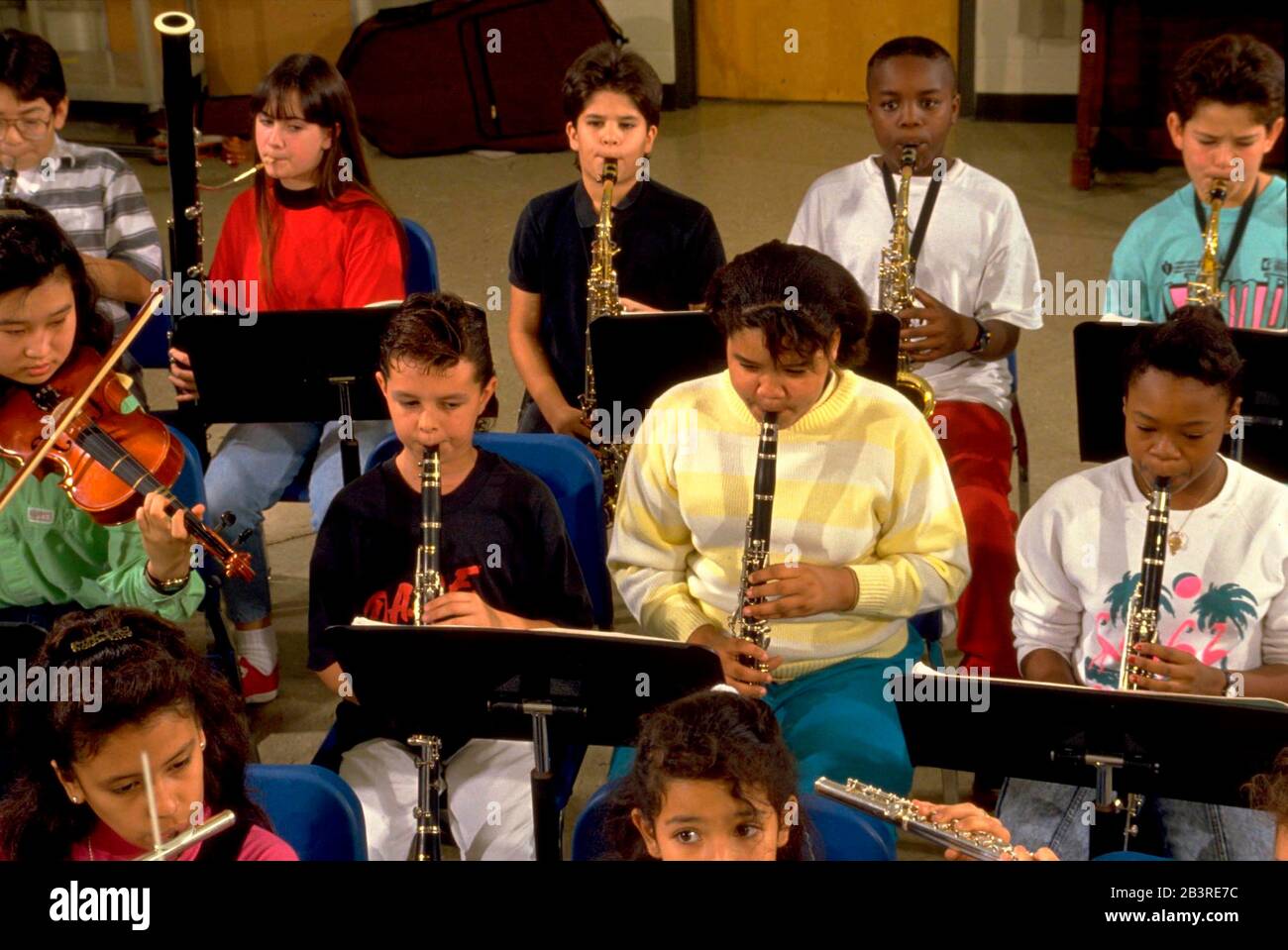 Austin Texas USA: Middle school orchestra members rehearse in band hall during music class. MR ©Bob Daemmrich Stock Photo