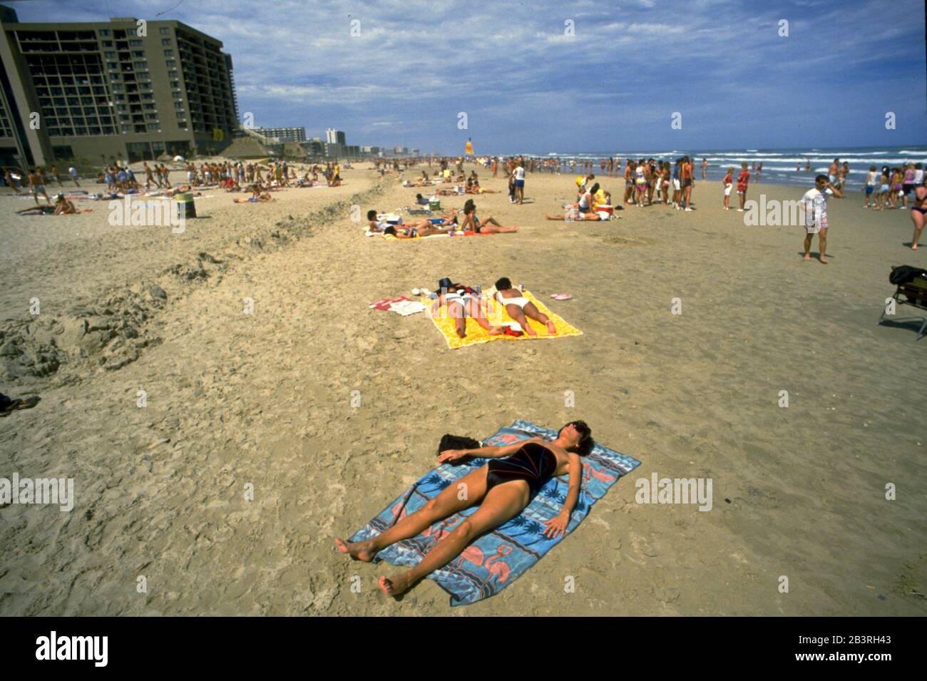 South Padre Island Texas, circa 1989: Young woman soaks up the sun at this popular Spring Break destination for college students. ©Bob Daemmrich Stock Photo