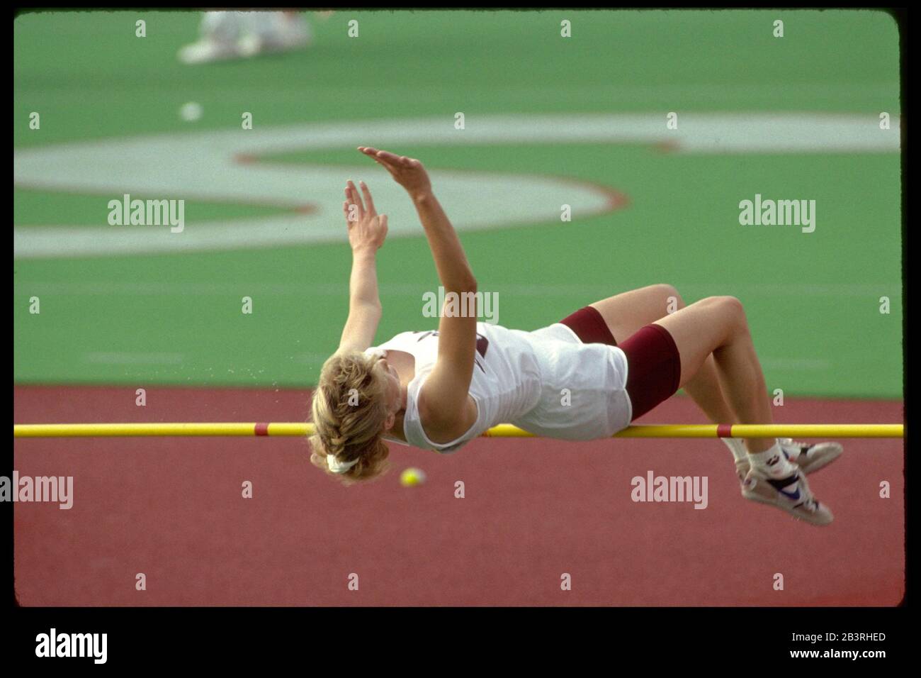 Austin Texas USA, circa 1992: Female high jumper attempts to clear the bar at high school state track and field championship meet. ©Bob Daemmrich Stock Photo