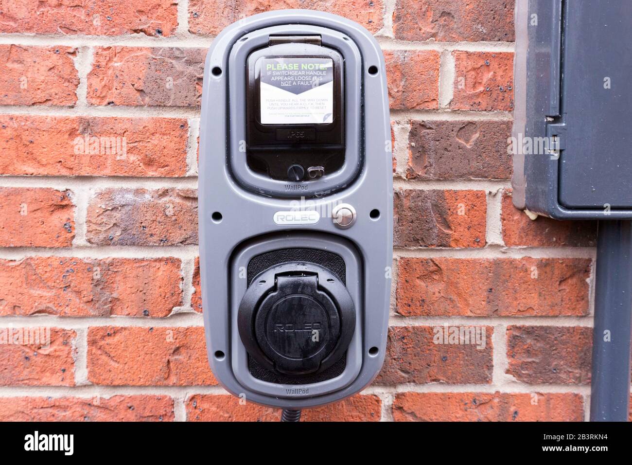 Electric car charging point at a home in England Stock Photo