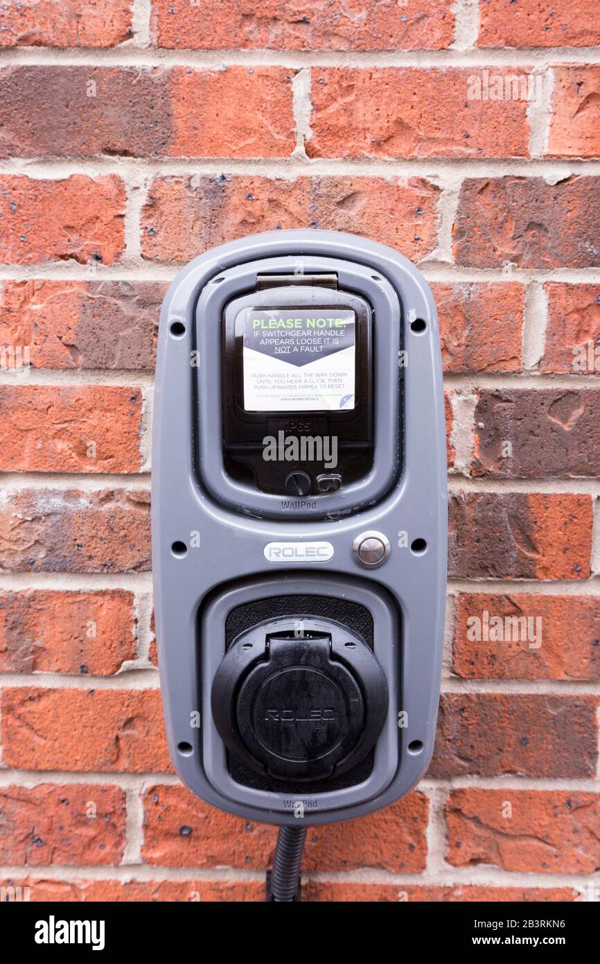 Electric car charging point at a home in England Stock Photo