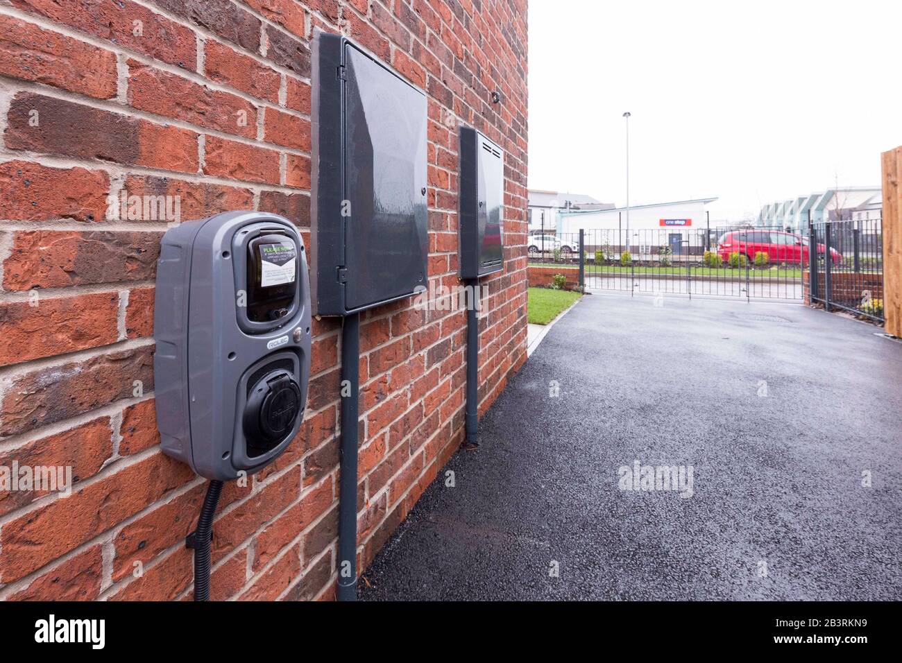 Electric car charging point at a home in England Stock Photo