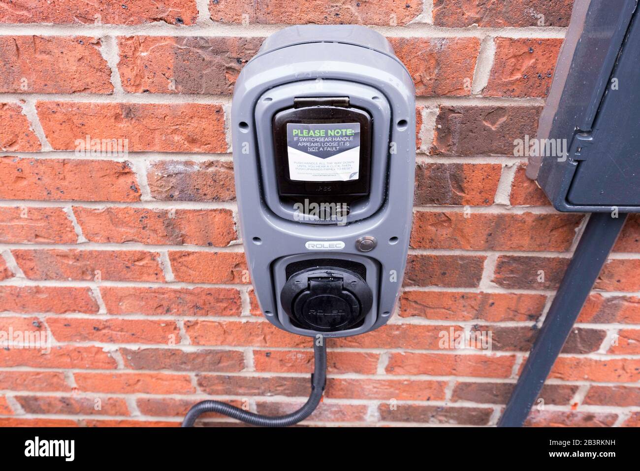 electric car charging point at a new build house in Manchester England Stock Photo